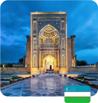 Illuminated ornate building with intricate tilework under a twilight sky, featuring a reflecting walkway. Uzbekistan flag in corner. Calm and majestic.